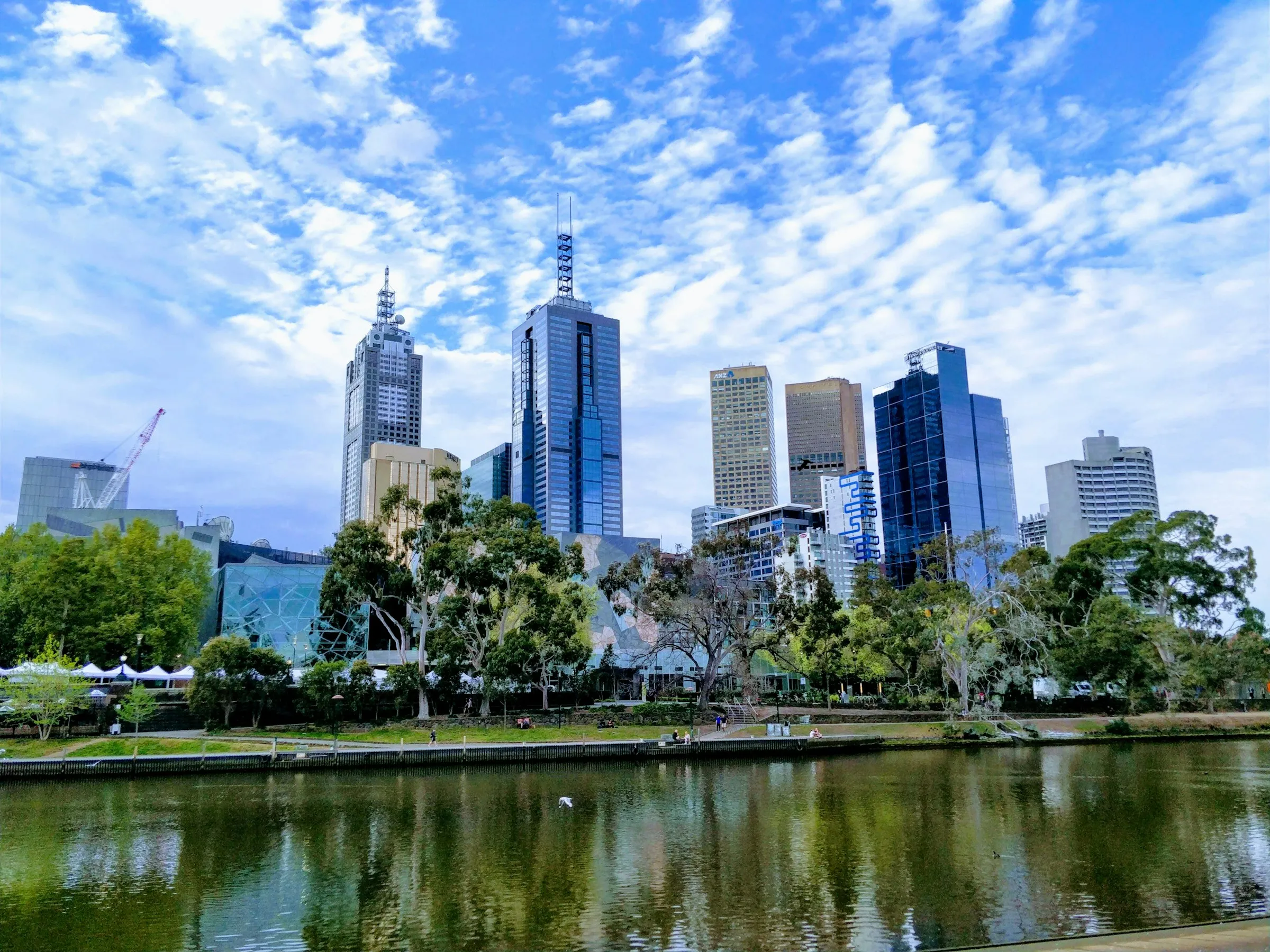 Melbourne's CBD skyline above the Yarra River on a sunny day